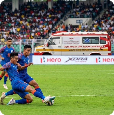 Ambulance and medical staff on standby at a sports stadium